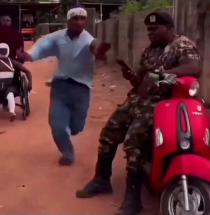 バイクに座る兵士と駆け寄る男性