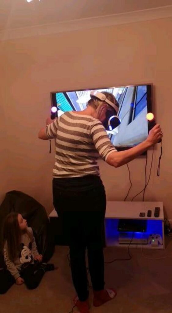 VRゲームで遊ぶ女性と見守る子供