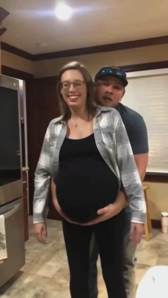 大きなお腹を支えて微笑む男女