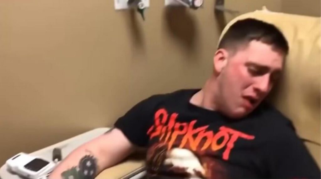 病院で泣くスリップノットＴシャツの男